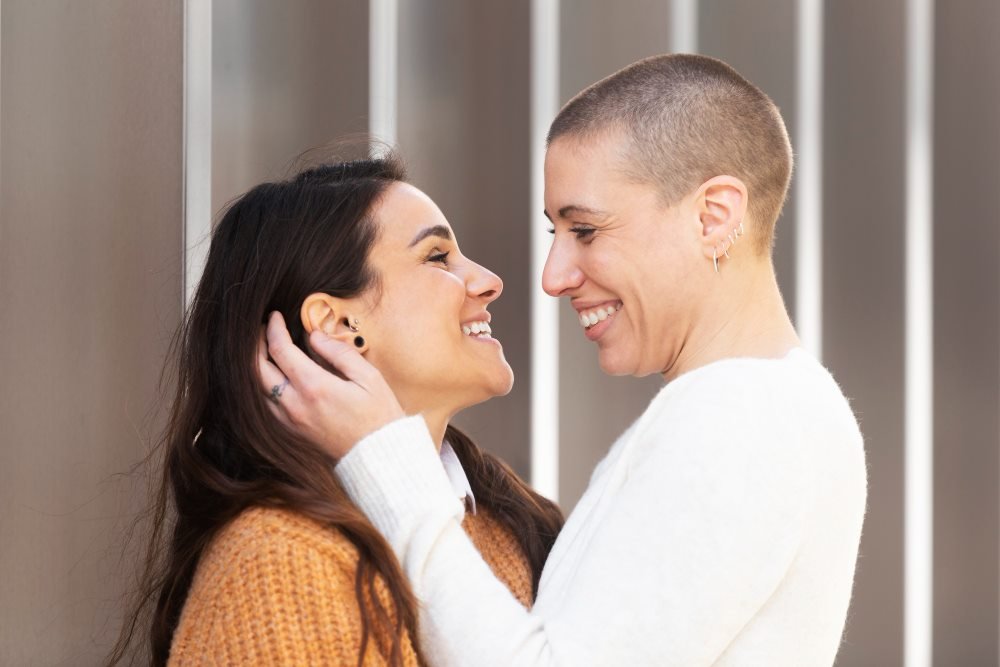 Two adults smiling warmly at each other