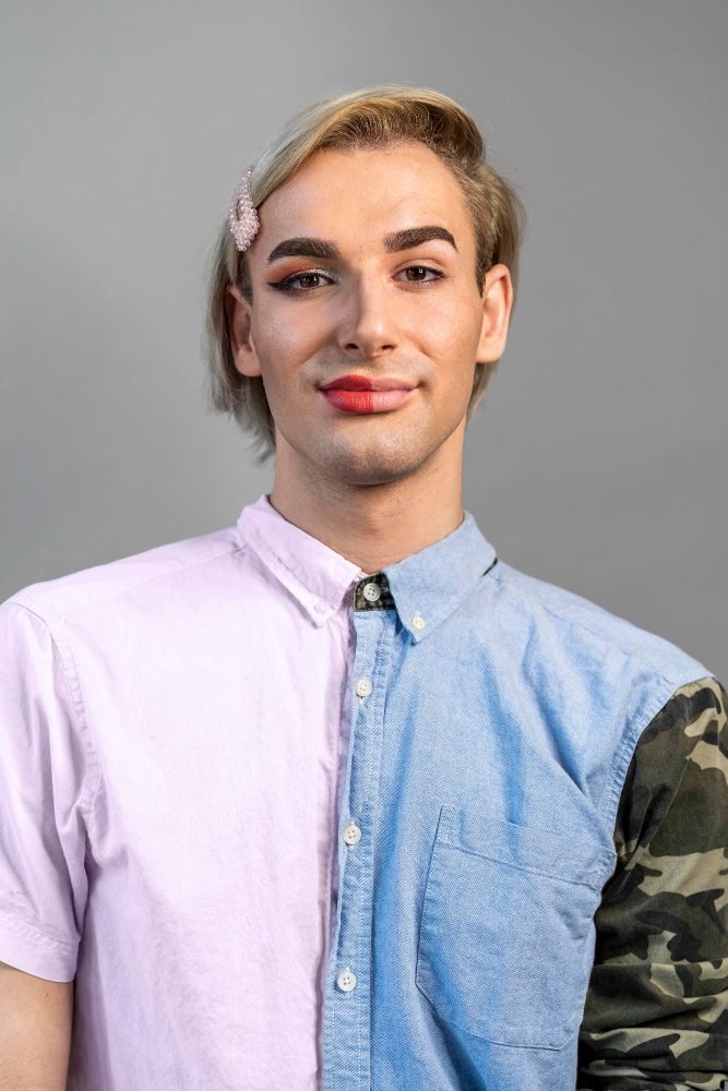 Trans man wearing a blue and pink shirt